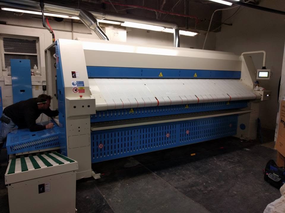 Commercial flatwork ironer installation at an on-premise laundry